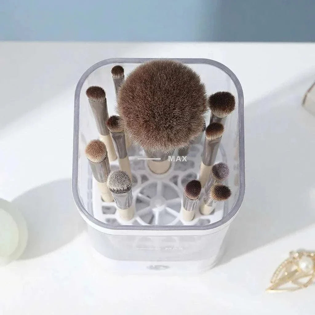 CleanLuxe Automatic Makeup Brush Cleaner with various natural bristle makeup brushes in a transparent container and soft visible bristles