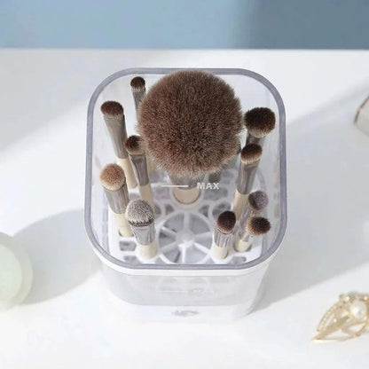 CleanLuxe Automatic Makeup Brush Cleaner with various natural bristle makeup brushes in a transparent container and soft visible bristles